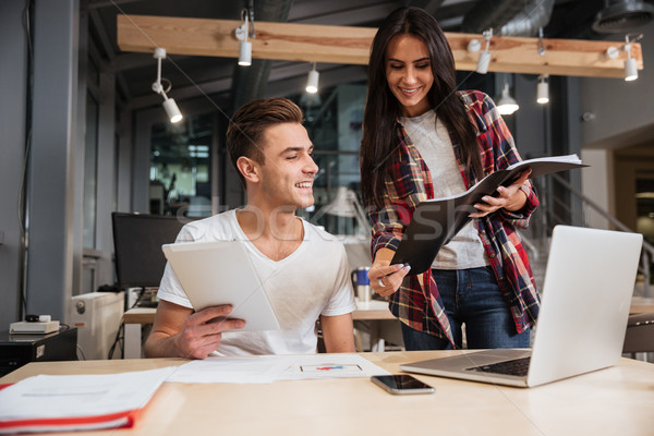 Coworkers by the table in office Stock photo © deandrobot