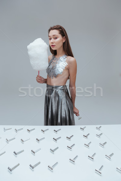 Woman in blade necklace with cotton candy and vintage razor Stock photo © deandrobot