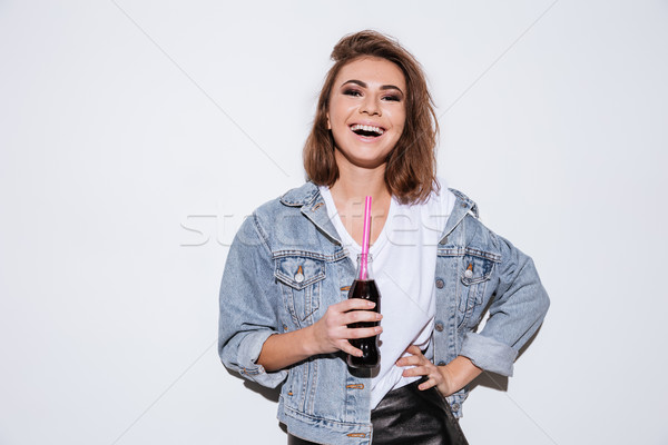 Laughing woman drinking aerated sweet water. Stock photo © deandrobot
