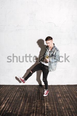 Vertical image of Hipster in snap back flying on mop Stock photo © deandrobot