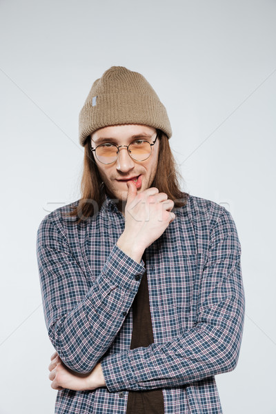 Vertical image of Pensive hipster in eyeglasses Stock photo © deandrobot