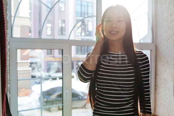 Asian woman near the window in cafeteria Stock photo © deandrobot