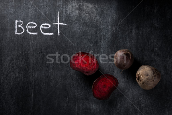 Cut beet over dark chalkboard background Stock photo © deandrobot