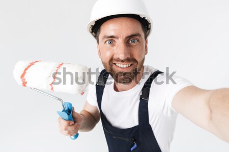Man sitting on floor with roller isolated Stock photo © deandrobot