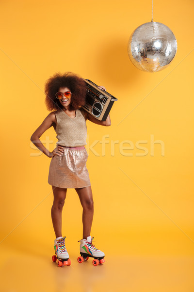 Full length portrait of cheerful african disco woman with hand o Stock photo © deandrobot