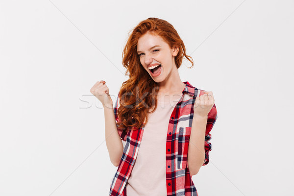 Izgatott gyönyörű fiatal vörös hajú nő hölgy mutat Stock fotó © deandrobot