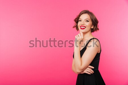 Portrait of a pretty woman looking away at copy space Stock photo © deandrobot