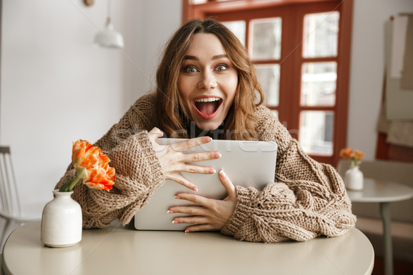Funny photo of cheerful woman in knitted sweater looking on came Stock photo © deandrobot