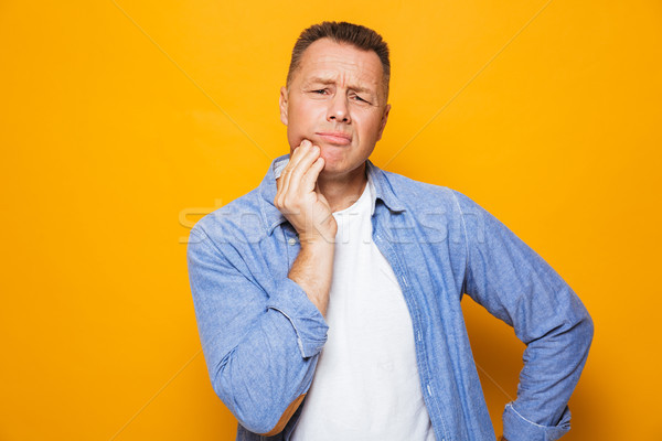 Portrait of an annoyed middle aged man suffering Stock photo © deandrobot