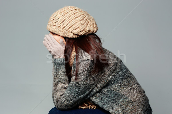 Young woman in warm winter outfit on gray background Stock photo © deandrobot