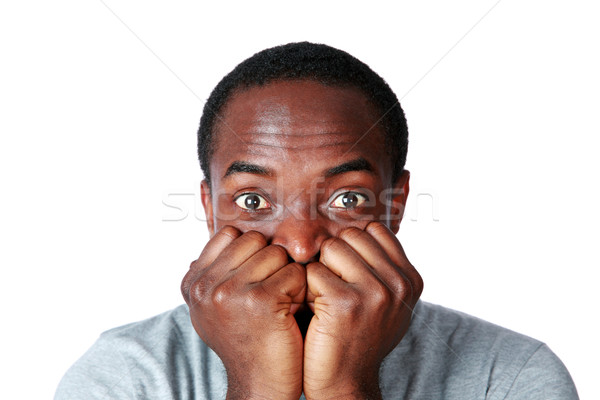 Portrait of a nerveous african man over white background Stock photo © deandrobot