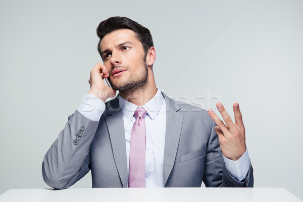 Pensive businessman talking on the phone Stock photo © deandrobot
