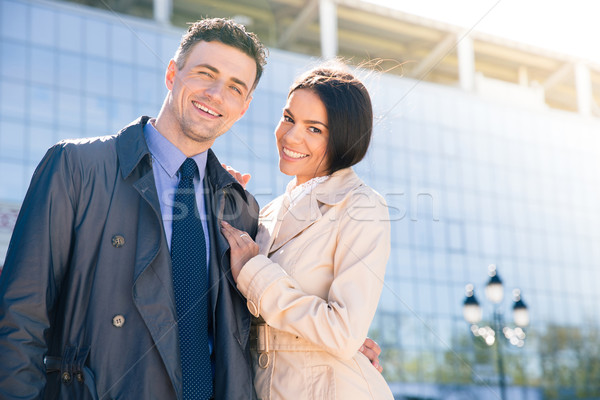 Smiling beautiful couple hugging outdoors  Stock photo © deandrobot