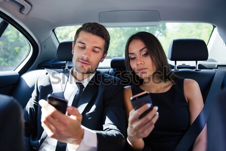 Businesswoman and businessman reading papers in car Stock photo © deandrobot