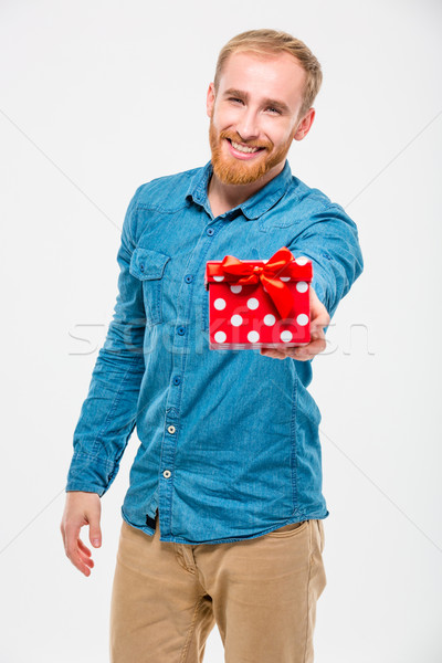 Attractive positive male with beard giving present to you Stock photo © deandrobot