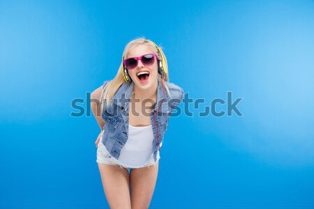 Stylish female teenager licking lollipop Stock photo © deandrobot