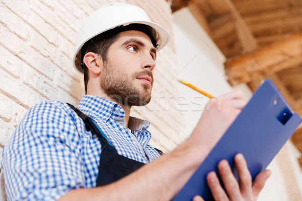 Close-up portrait of a smart builder thinking about something Stock photo © deandrobot
