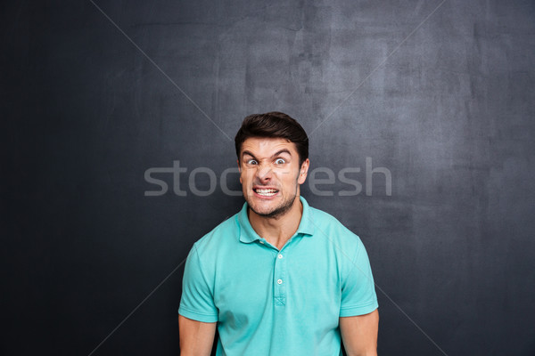 Gek agressief jonge man Blauw tshirt Blackboard Stockfoto © deandrobot