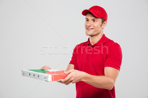 Side view of pizza delivery man Stock photo © deandrobot