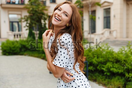 Smiling happy girl in dress and hat riding retro bicycle Stock photo © deandrobot