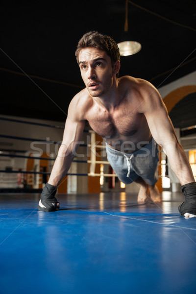 Strong man pushing up while training Stock photo © deandrobot