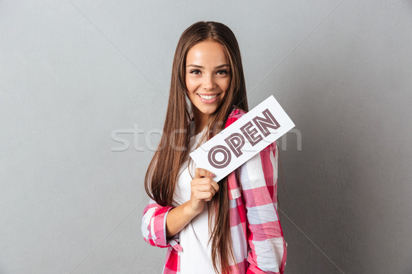 Portré derűs fiatal barna hajú nő tart Stock fotó © deandrobot