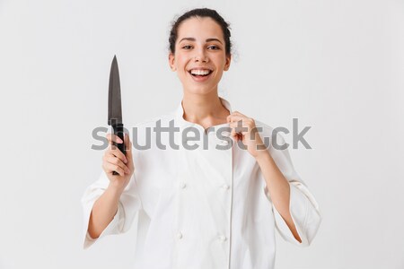 Close-up photo of female housekeeper in uniform hiding her tips  Stock photo © deandrobot