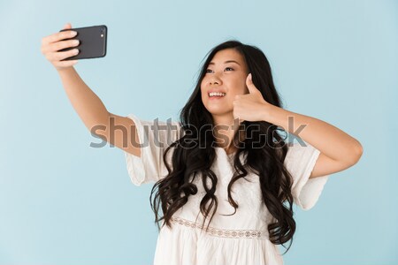 Portrait of a sensual girl dressed in tank-top taking a selfie Stock photo © deandrobot