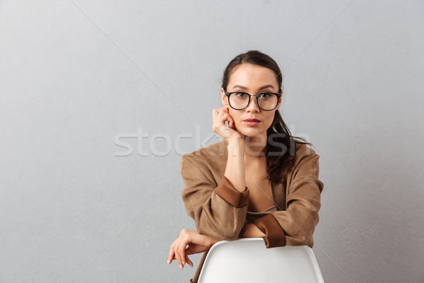 Portrait of a concentrated young asian woman Stock photo © deandrobot