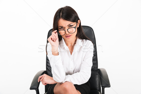 Portrait of a doubtful asian businesswoman Stock photo © deandrobot