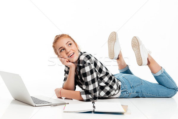 Side view of smiling ginger woman in shirt and jeans Stock photo © deandrobot