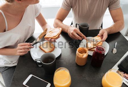 Cropped image of couple have tasty breakfast in the kitchen Stock photo © deandrobot