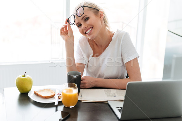 Stock photo: Young happy lady take off glasses and looking camera in kitchen