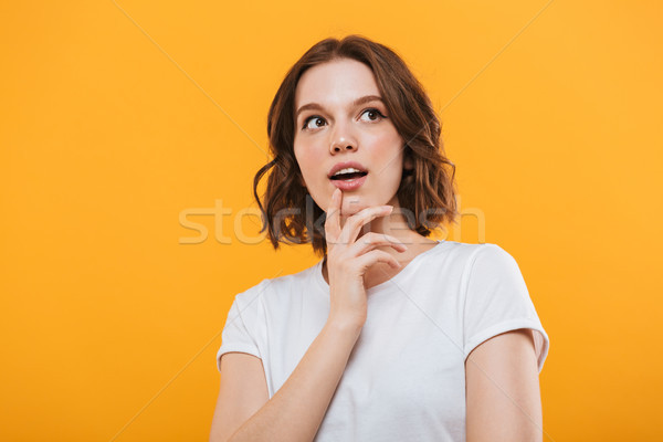 Emotional cute young woman standing isolated Stock photo © deandrobot