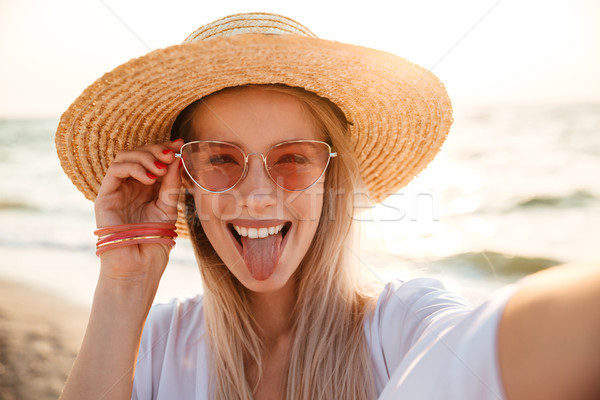 Cheerful young girl in summer hat and swimwear Stock photo © deandrobot