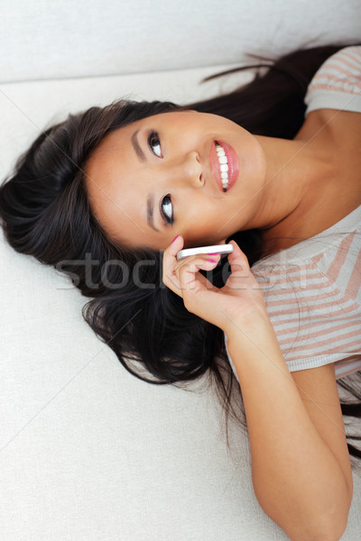 Heureux asian femme canapé parler téléphone [[stock_photo]] © deandrobot