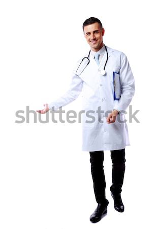 Happy male doctor presenting you something on white background Stock photo © deandrobot