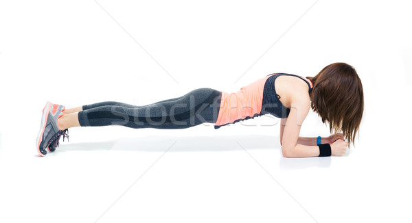 Sporty woman doing exercises on the floor Stock photo © deandrobot