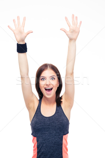 Laughing fitness woman standing with raised hands up Stock photo © deandrobot