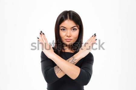 Cute woman holding shoes over gray background Stock photo © deandrobot