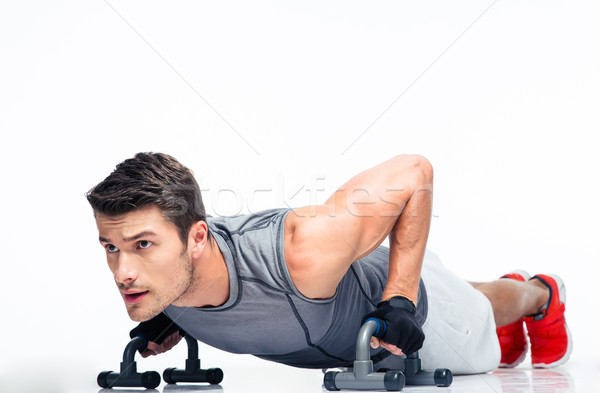 Fitness young man doing push ups Stock photo © deandrobot