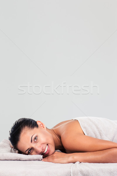 Charming woman lying on massage lounger  Stock photo © deandrobot