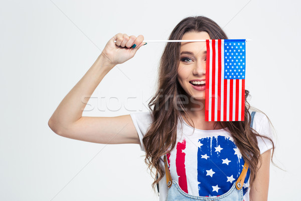 Smiling woman covering her eye with USA flag  Stock photo © deandrobot
