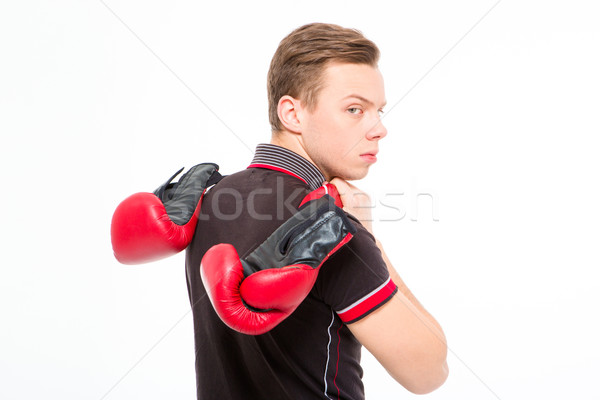 Stock photo: Annoyed sad blond young male carrying boxing gloves 
