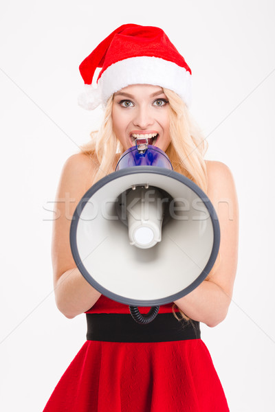 Joyful girl in santa clause dress and hat with megaphone  Stock photo © deandrobot
