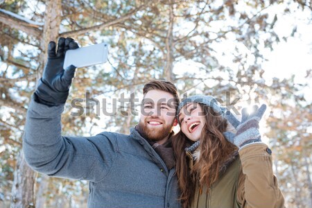 Couple making selfie photo in winter park Stock photo © deandrobot