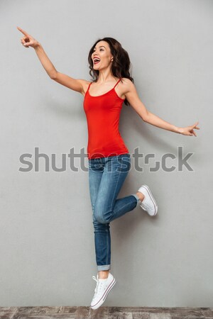 Stressed young woman showing empty pockets Stock photo © deandrobot
