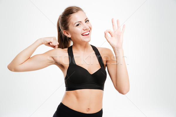 Mosolyog sportos nő mutat ok felirat Stock fotó © deandrobot