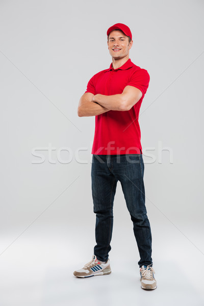 Deliveryman with arms crossed Stock photo © deandrobot
