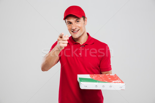 Pizza delivery man shows at camera Stock photo © deandrobot